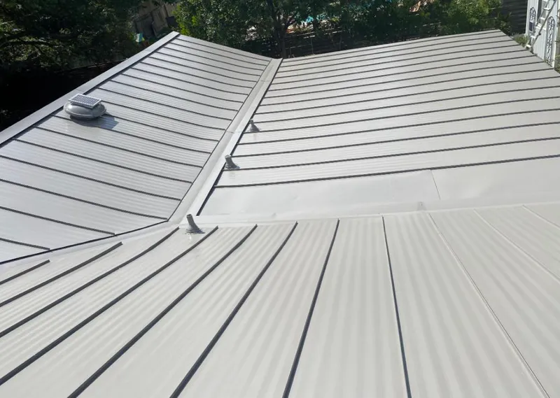 Solar attic fan installed on a metal roof for Roof Ventilation in Hyde Park